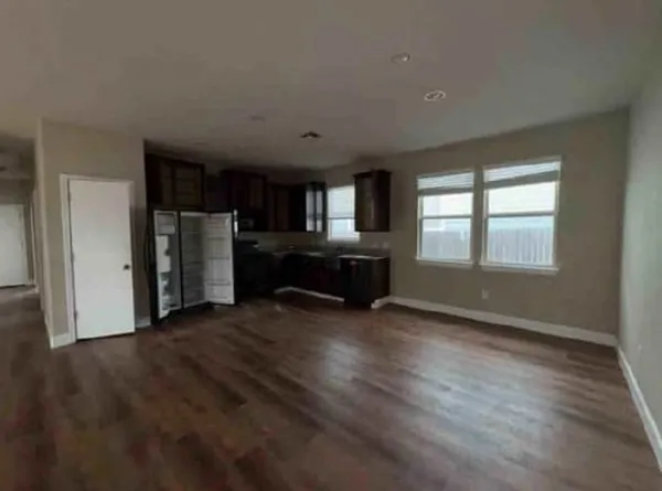 a view of a livingroom with a kitchen