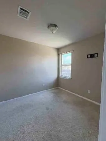 an empty room with windows and closet
