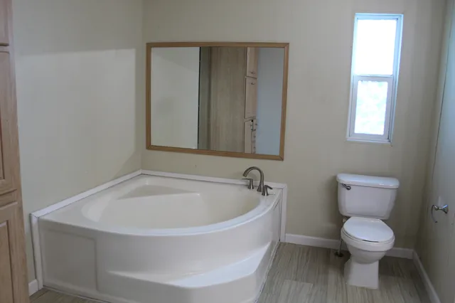 a white toilet sitting next to a window