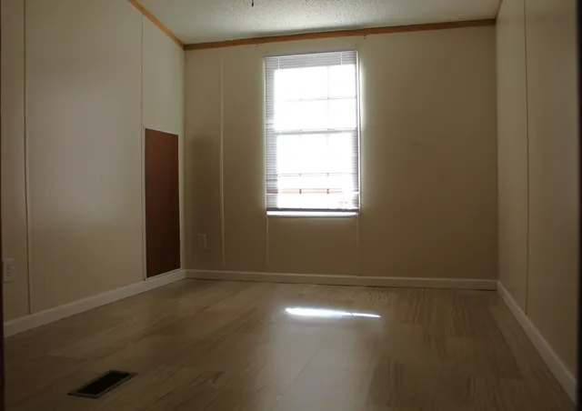 an empty room with a empty space and window