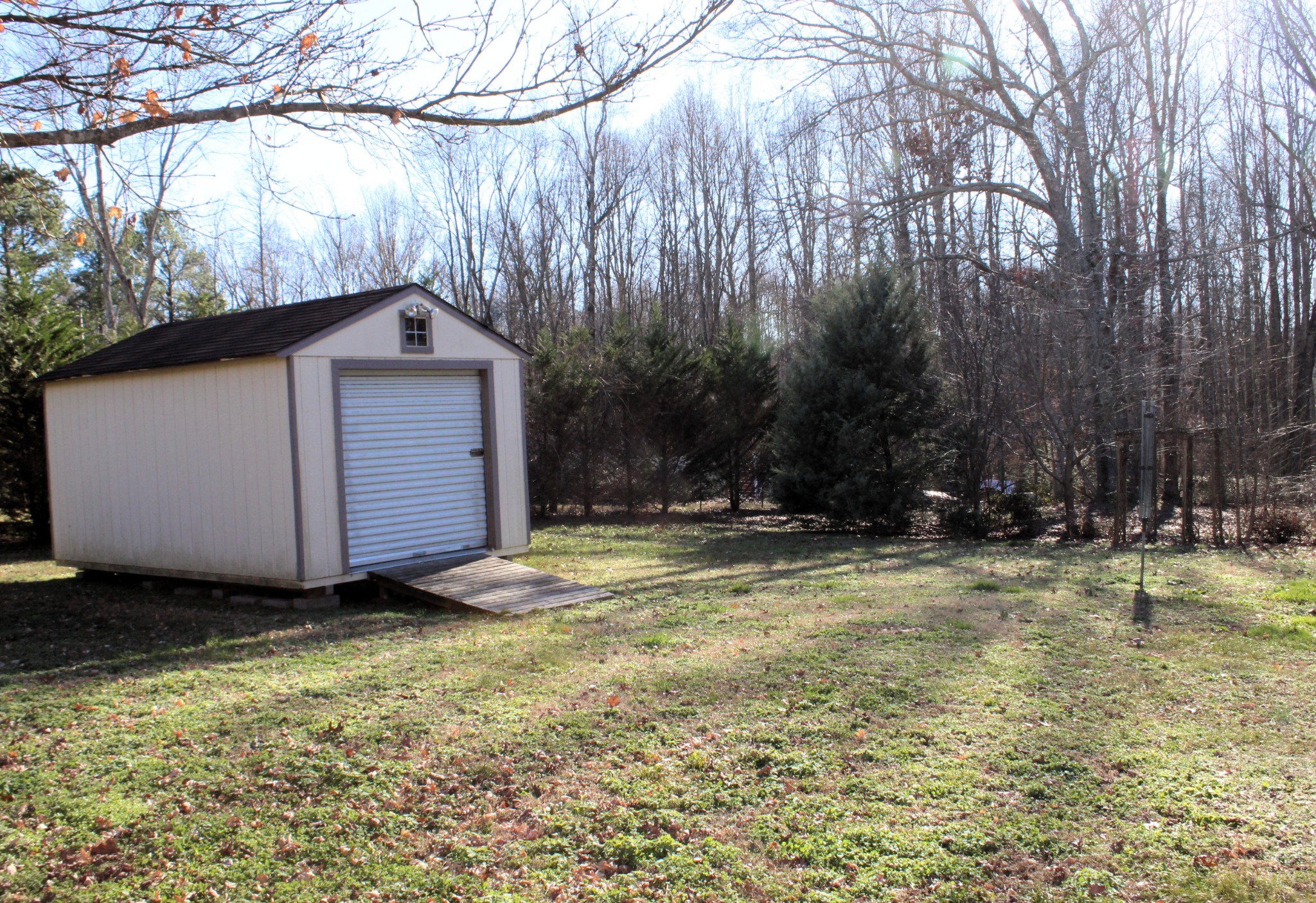108 Wimbley Road Estill Springs, TN 37330 - Photo 3 of 27 a view of a backyard with large trees