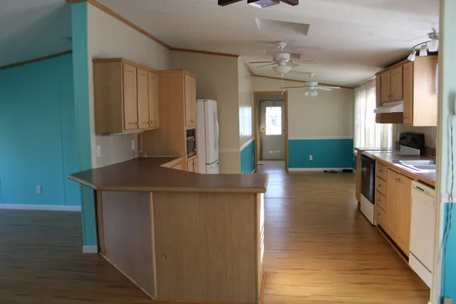a kitchen with stainless steel appliances a sink stove and cabinets
