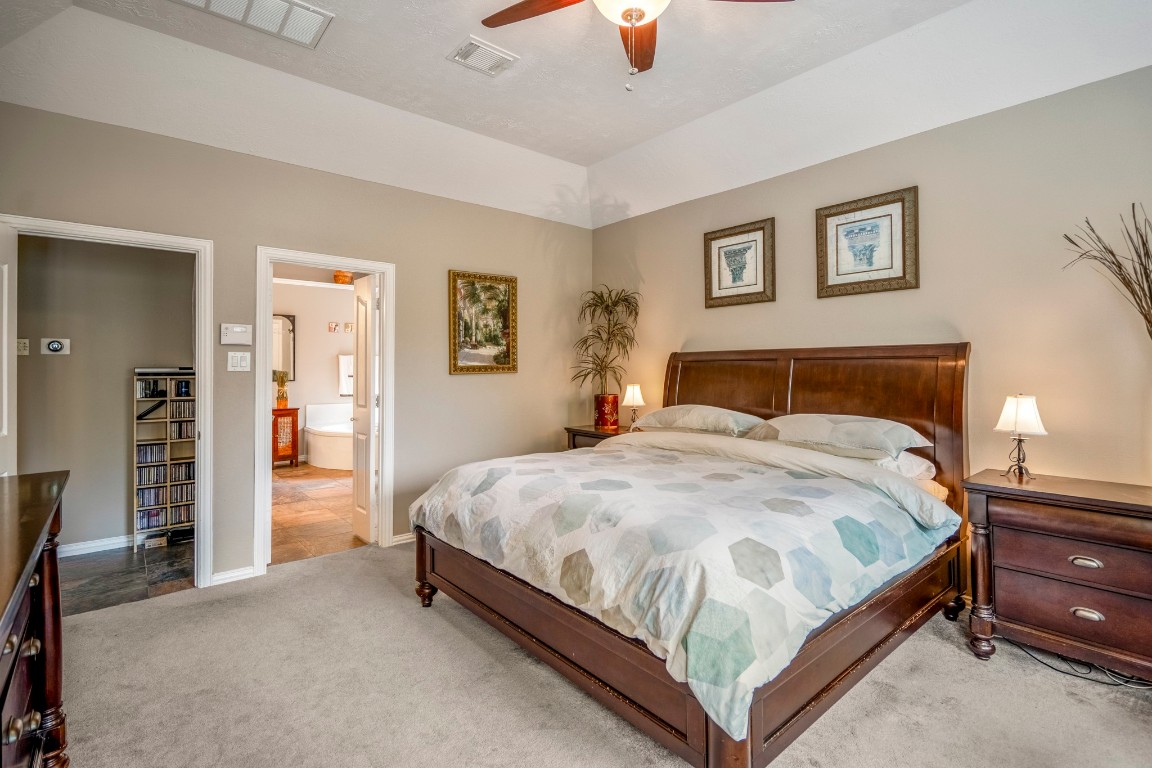 6811 PInehearth Court Spring, TX 77379 - Photo 19 of 50 From this angle, the scale of the primary suite really comes into view—vaulted ceilings overhead and plenty of room for full furnishings without feeling crowded. The en-suite bath sits just beyond, creating an easy, private flow to start and end your day.