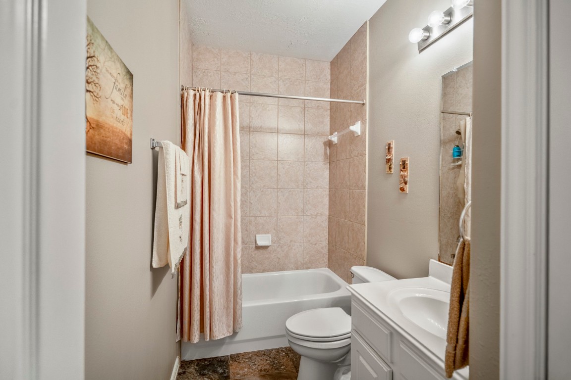 6811 PInehearth Court Spring, TX 77379 - Photo 27 of 50 Tucked closer to the front of the home, this full bath serves the fourth bedroom and guests, offering a private feel within the home’s 3-way split layout. A tiled tub and shower surround and clean, neutral finishes create a simple, cohesive space that’s easy to maintain.