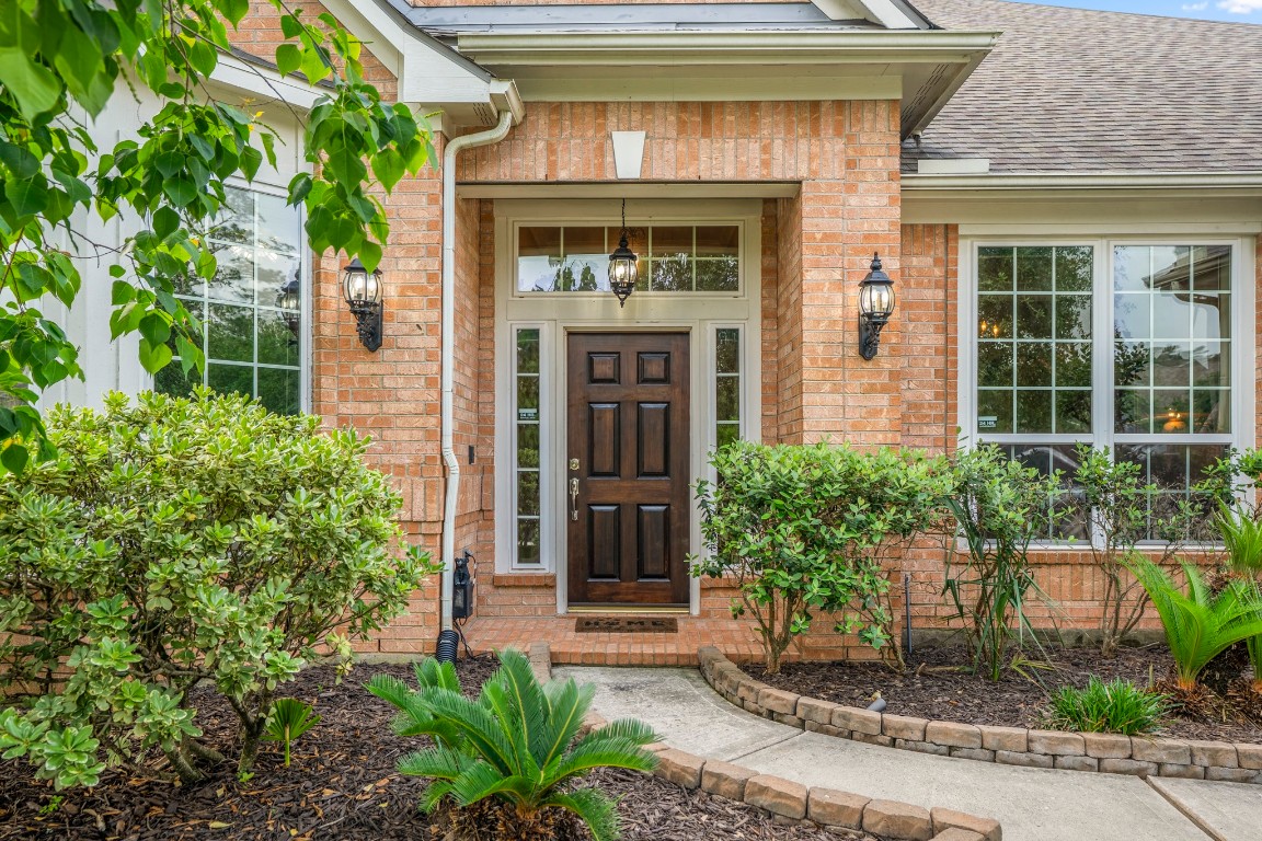 6811 PInehearth Court Spring, TX 77379 - Photo 3 of 50 The welcoming front entry sets the tone with brick detailing, covered porch, and elegant front door framed by natural light.