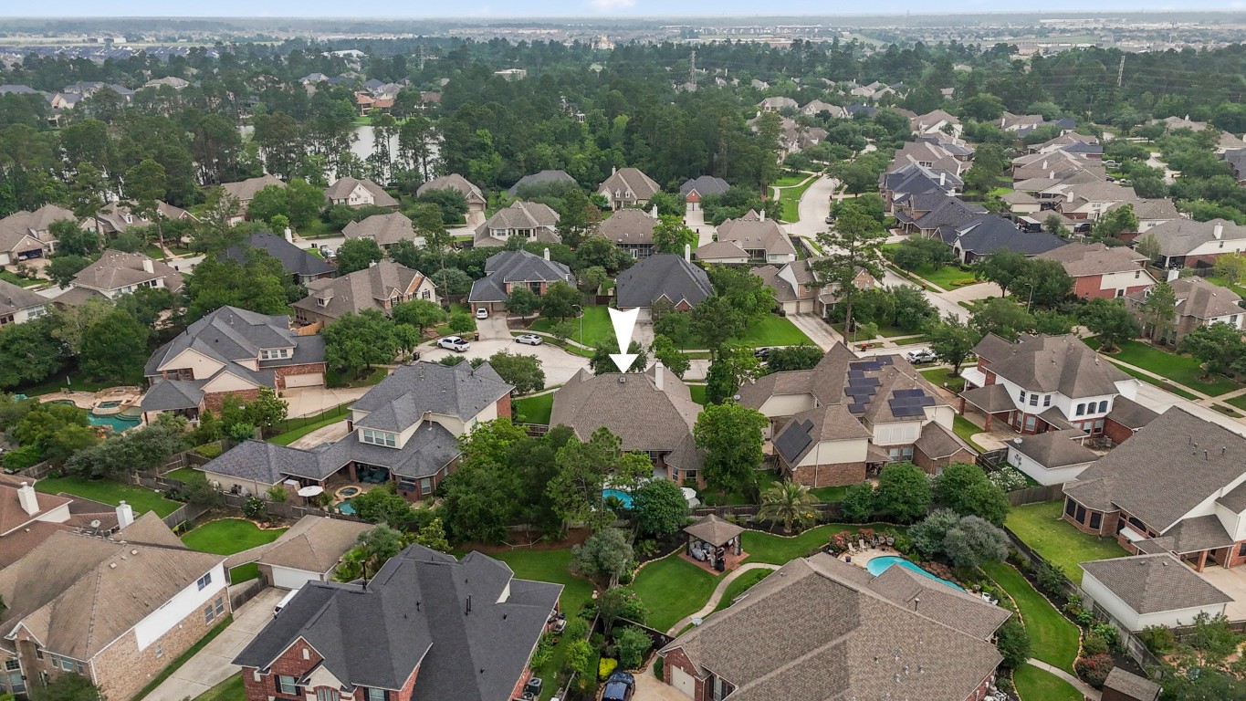 6811 PInehearth Court Spring, TX 77379 - Photo 38 of 50 Set within the established Windrose neighborhood, this aerial view highlights the home’s prime placement—tucked among mature trees with easy access to nearby amenities, all while enjoying a spacious lot and private backyard retreat.
