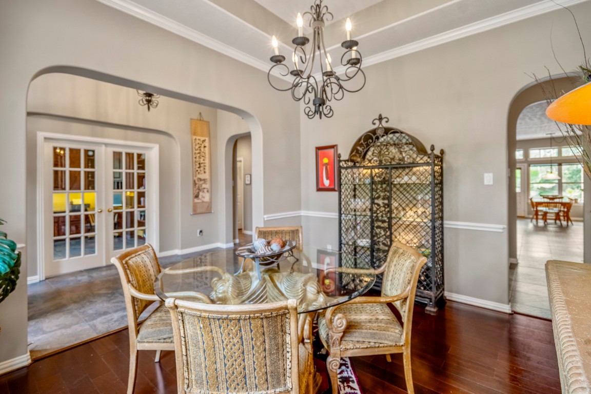 6811 PInehearth Court Spring, TX 77379 - Photo 8 of 50 This perspective of the dining room shows how the space ties into the rest of the home, with arched openings leading back toward the foyer and into the kitchen, where the breakfast area sits just beyond.