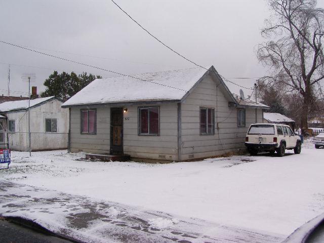 522 Cemetery Road Sunnyside, WA 98944 - Photo 1 of 4 a front view of a house with a yard covered in snow