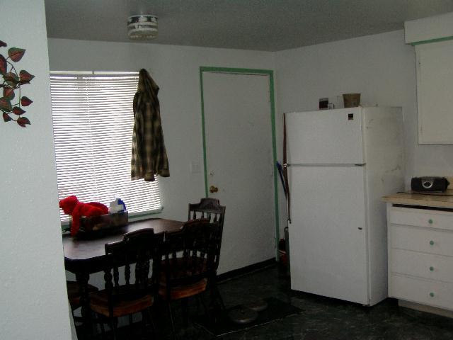 522 Cemetery Road Sunnyside, WA 98944 - Photo 2 of 4 a white refrigerator freezer sitting inside of a kitchen