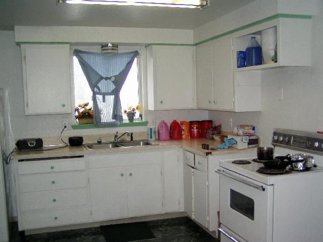 522 Cemetery Road Sunnyside, WA 98944 - Photo 3 of 4 a kitchen with a sink dishwasher stove and white cabinets