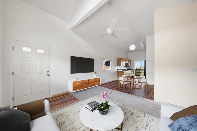 wooden floor in an empty room and a ceiling fan