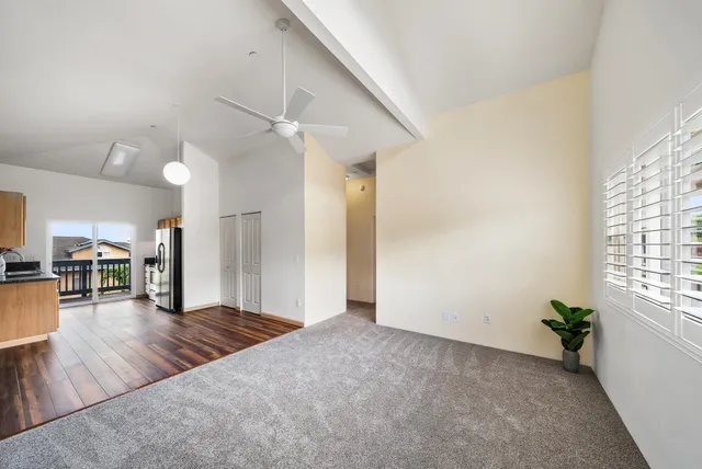 a view of a hallway with wooden floor and a chandelier