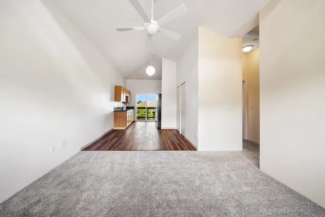 a bathroom with a granite countertop sink a toilet and shower