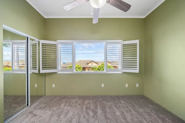 an empty room with a fan and a fan