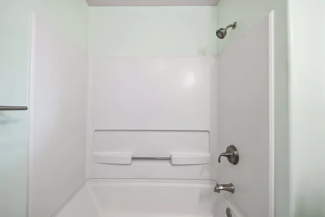 a bathroom with a shower and a toilet