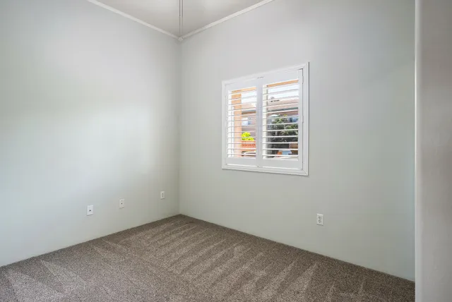 an empty room with windows and closet