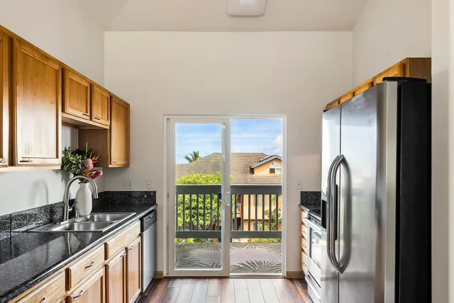 a kitchen with stainless steel appliances granite countertop a refrigerator and a sink