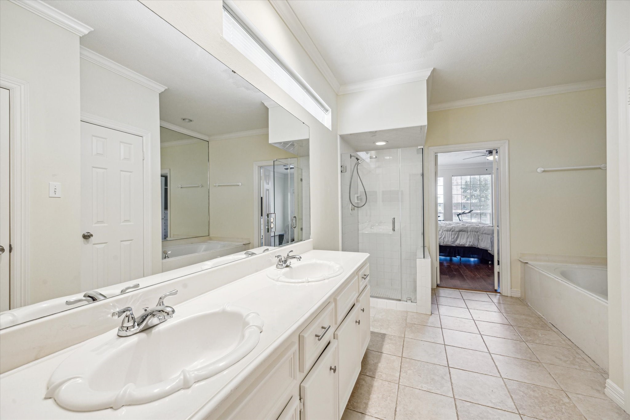7930 Tizerton Court Spring, TX 77379 - Photo 18 of 30 a spacious bathroom with a shower double sink and a mirror