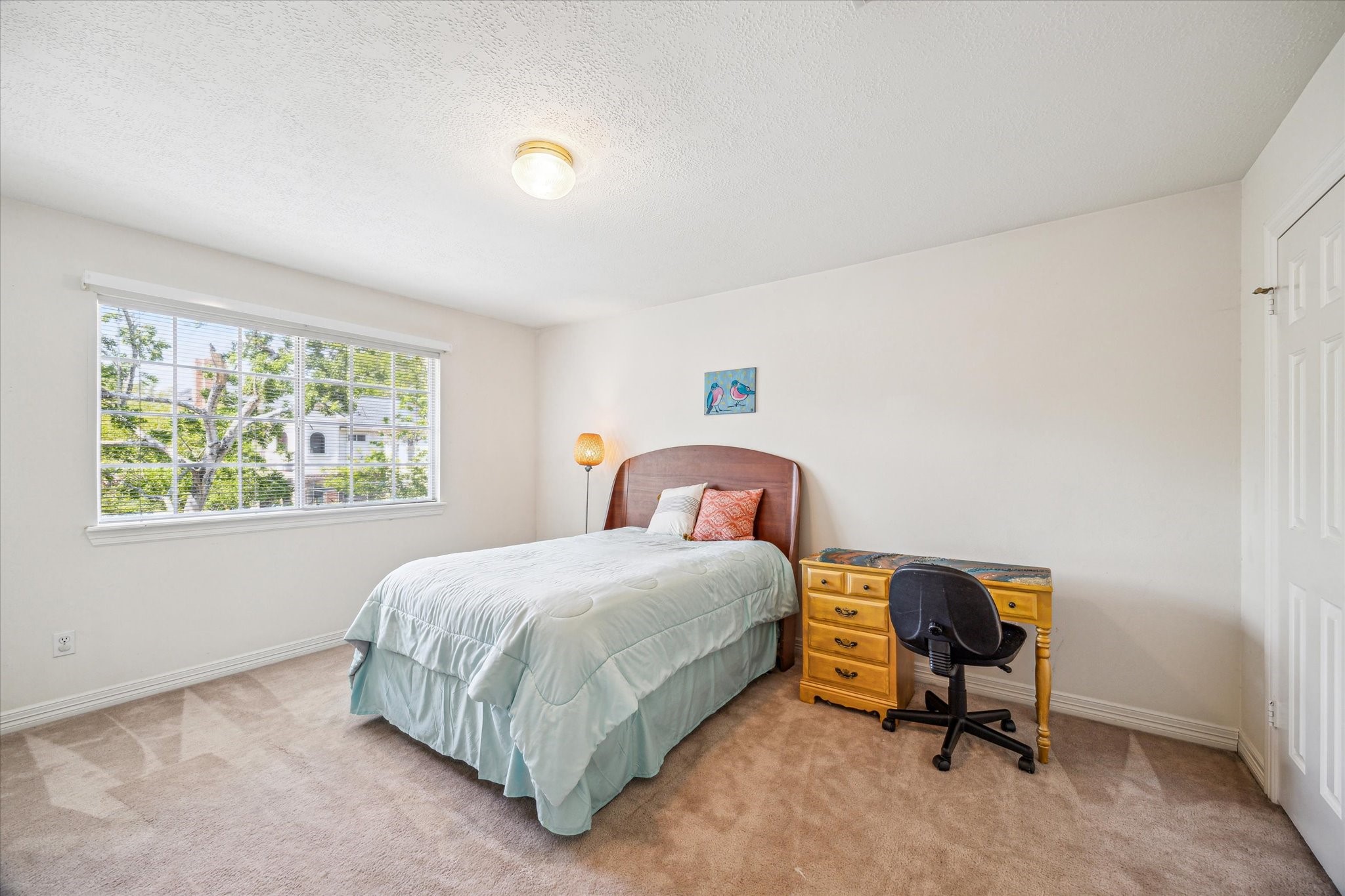 7930 Tizerton Court Spring, TX 77379 - Photo 27 of 30 a bedroom with a bed a table and a window