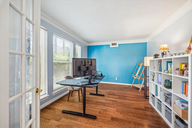 a view of a workspace with furniture and a book shelf
