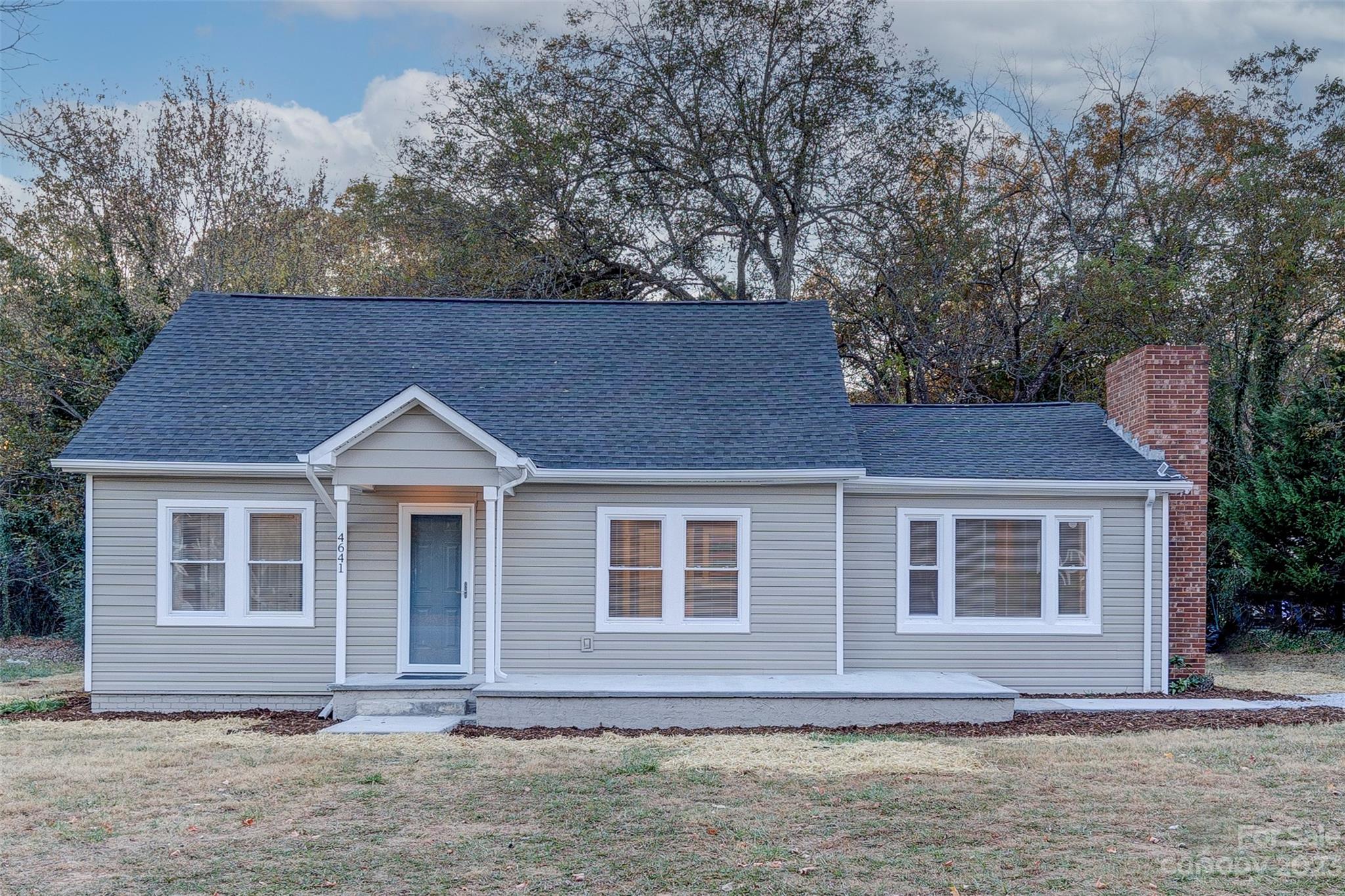 a front view of a house with a garden