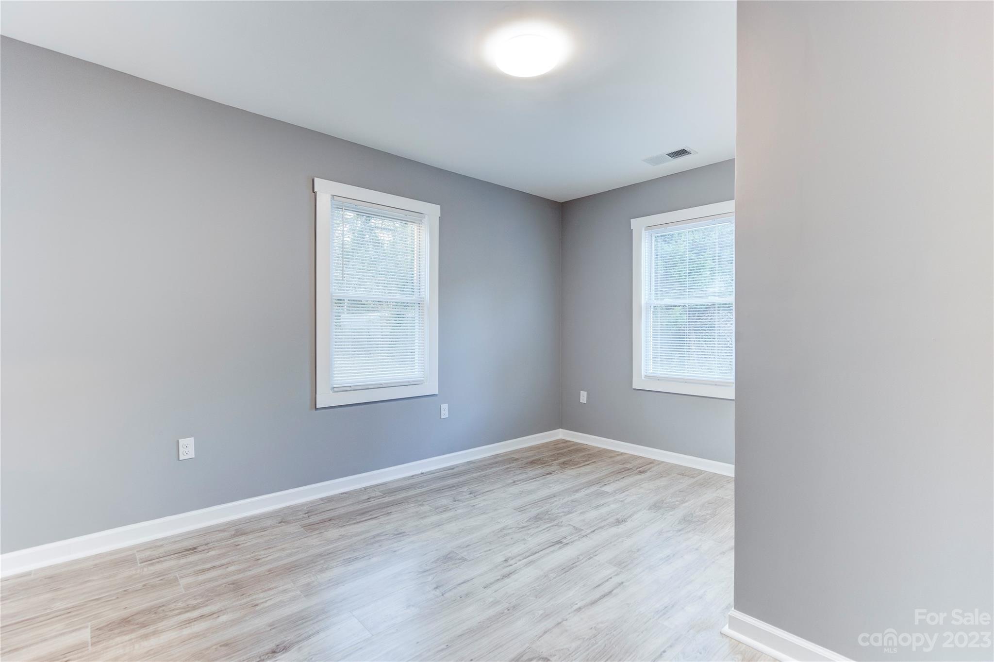 4641 Fallston Road Lawndale, NC 28090 - Photo 23 of 38 an empty room with wooden floor and windows