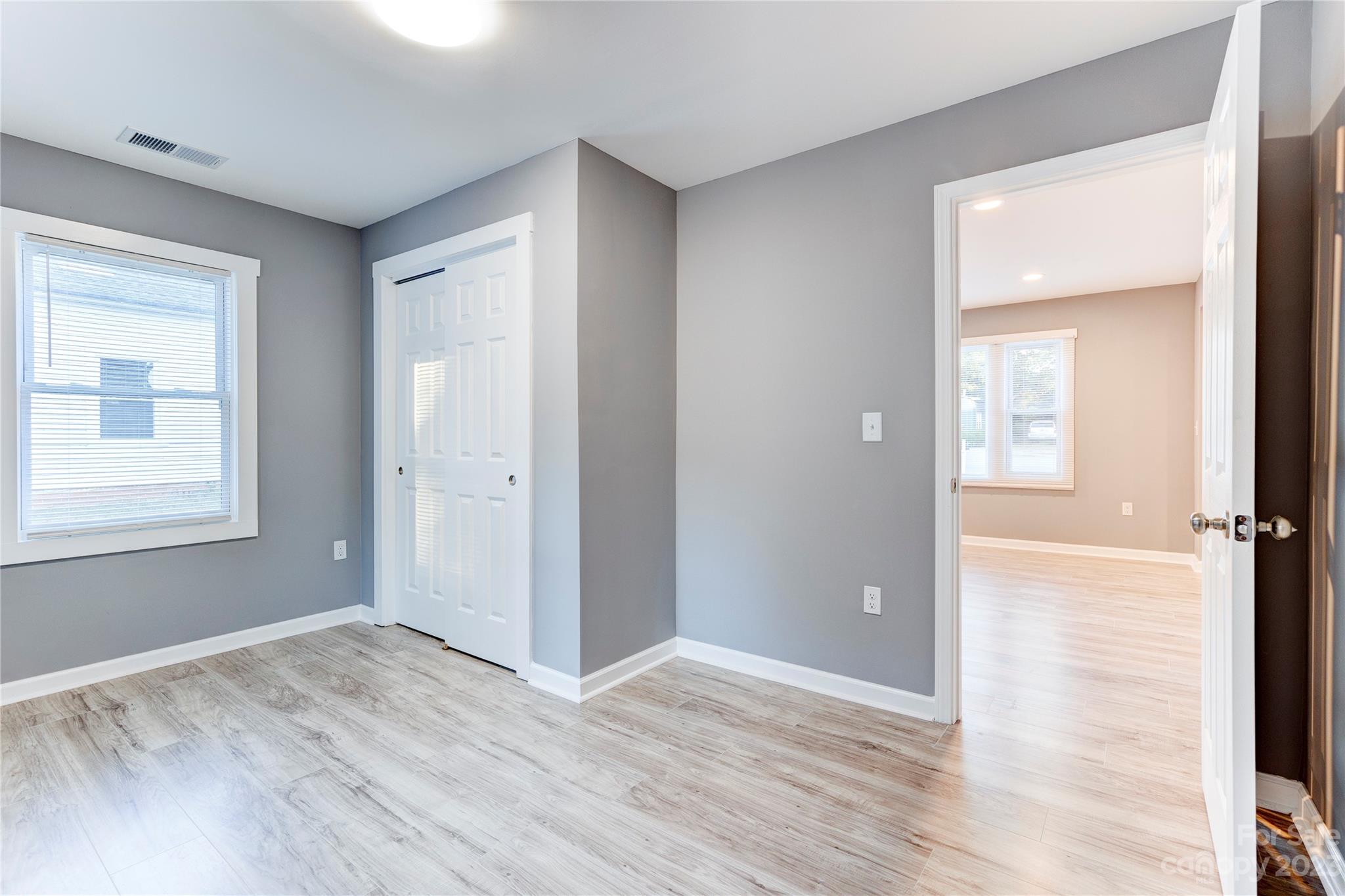 4641 Fallston Road Lawndale, NC 28090 - Photo 25 of 38 an empty room with wooden floor and windows