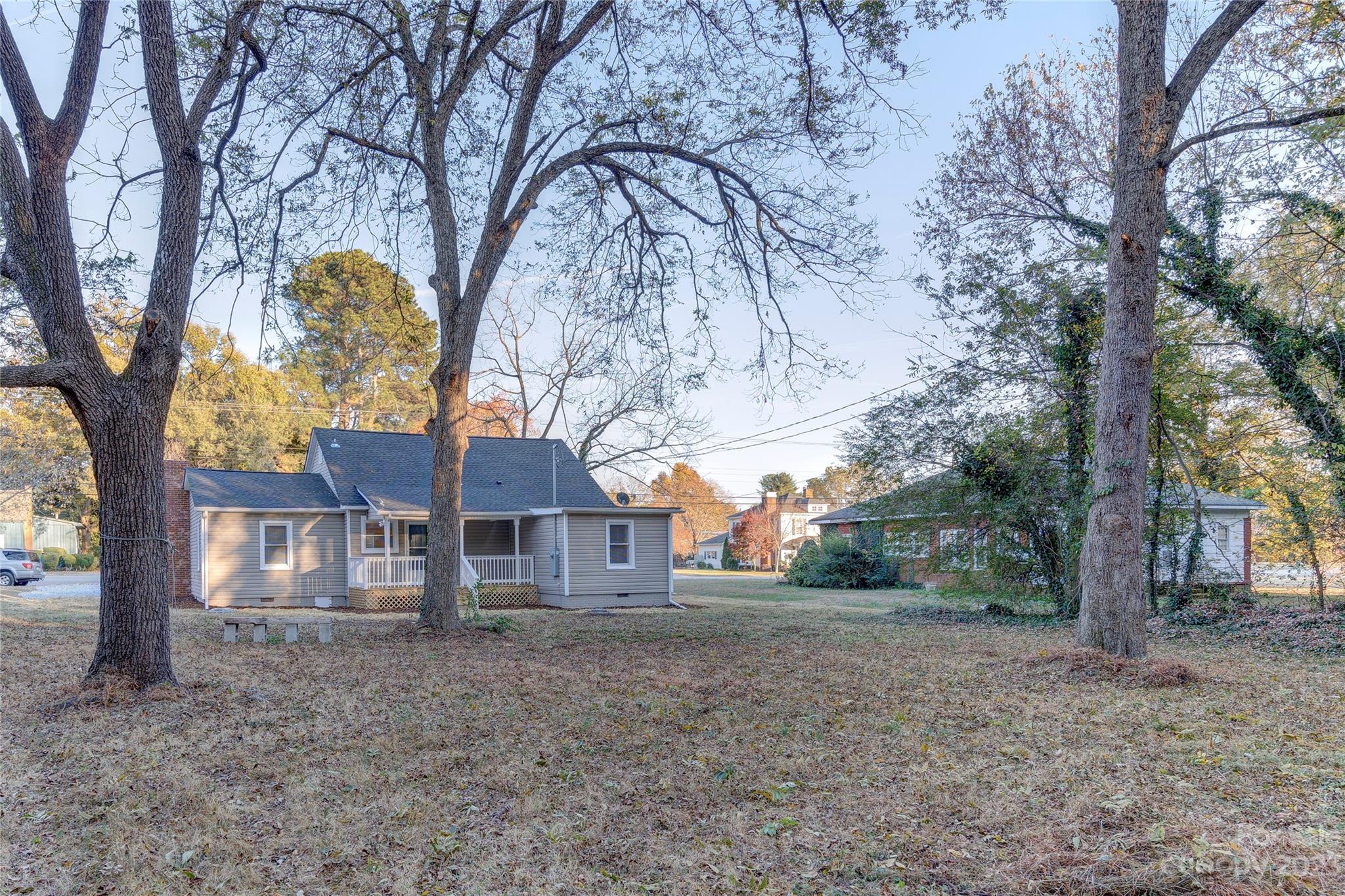4641 Fallston Road Lawndale, NC 28090 - Photo 10 of 38 a view of a house with large trees and a forest
