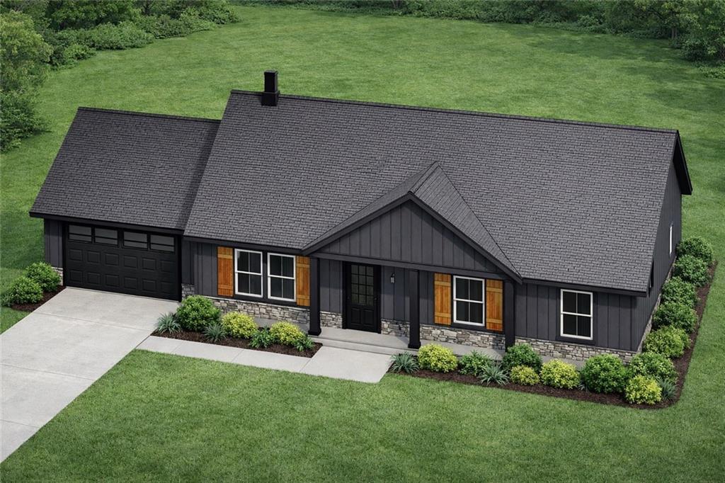 a aerial view of a house next to a yard and trees