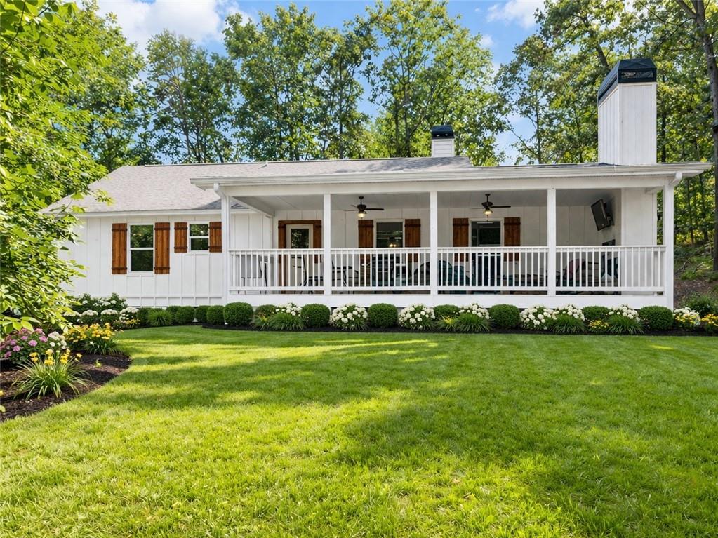 48 White Oak Trail Cleveland, GA 30528 - Photo 34 of 36 a front view of a house with a garden