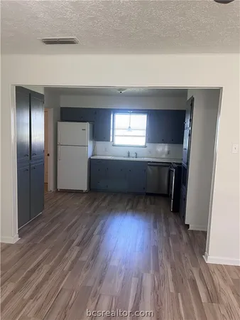 a room with wooden floor and staircase