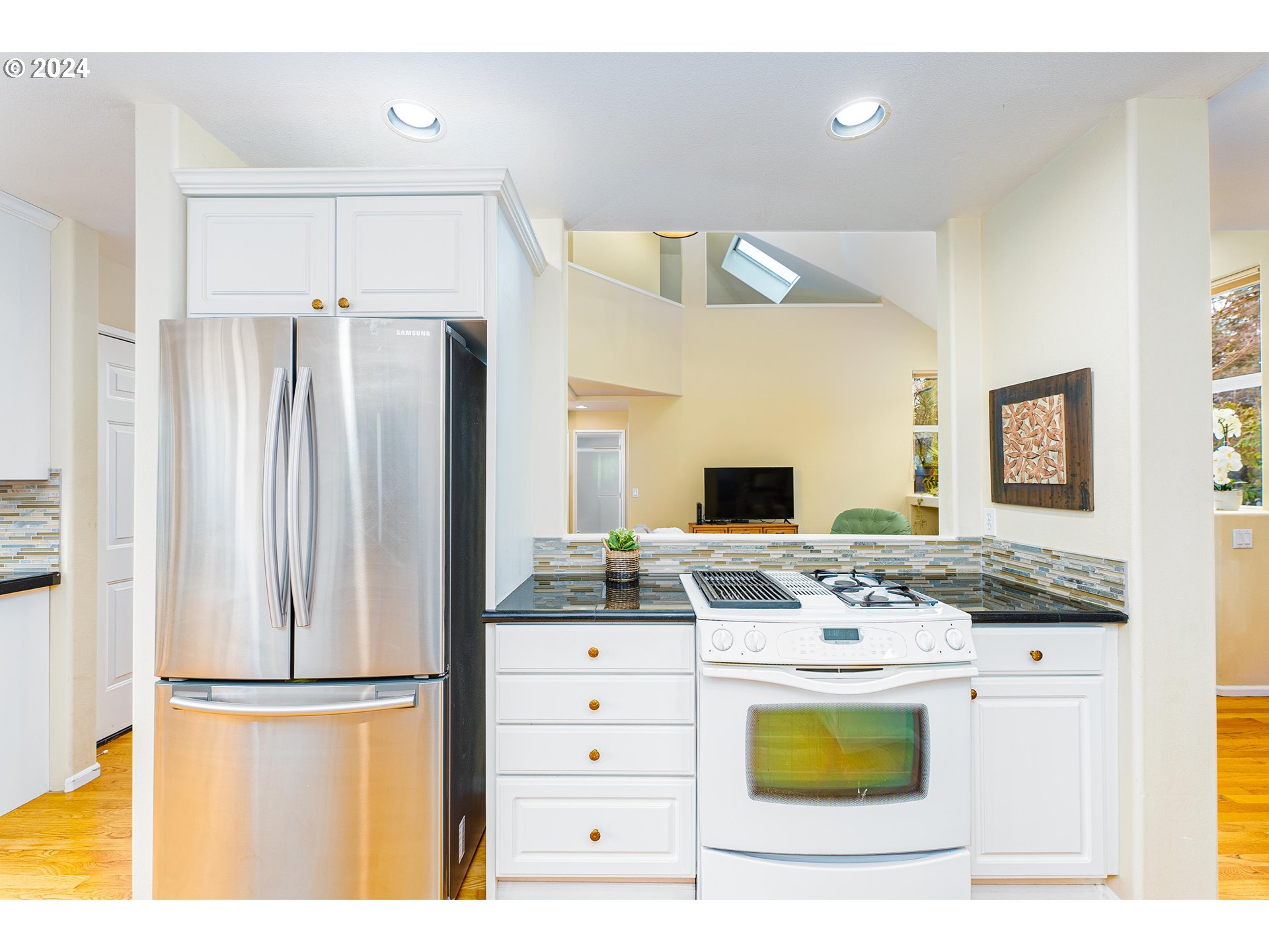 14915 Southwest Osprey Court Beaverton, OR 97007 - Photo 11 of 38 a kitchen with stainless steel appliances kitchen island a refrigerator sink and stove