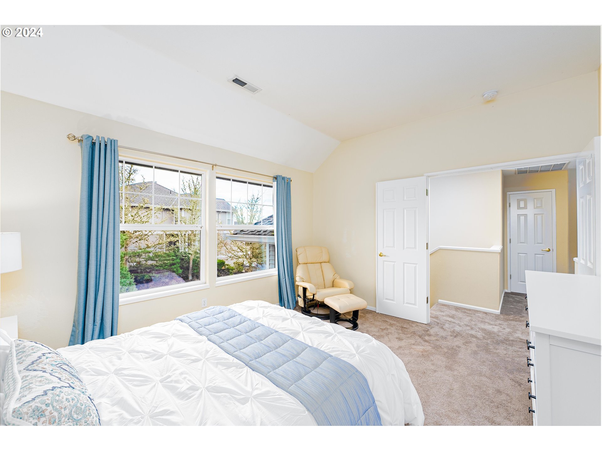 14915 Southwest Osprey Court Beaverton, OR 97007 - Photo 15 of 38 a bedroom with a bed and large windows