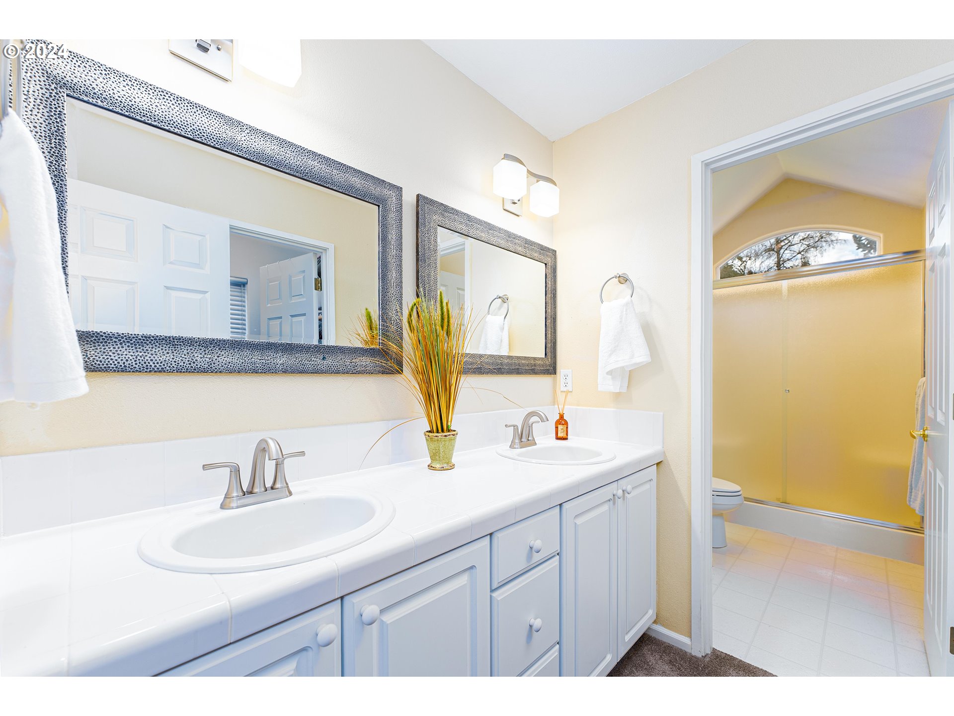 14915 Southwest Osprey Court Beaverton, OR 97007 - Photo 17 of 38 a bathroom with a sink double vanity and a mirror