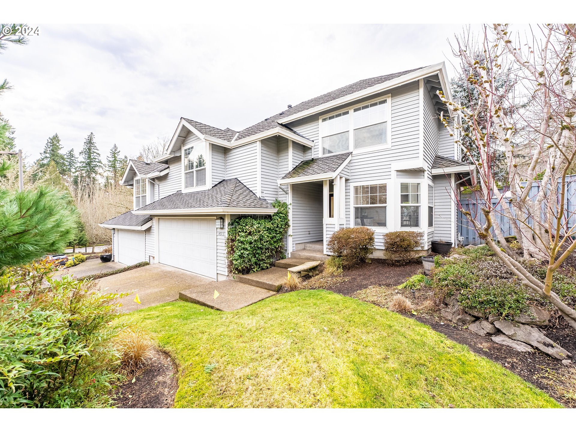 14915 Southwest Osprey Court Beaverton, OR 97007 - Photo 2 of 38 a view of a house with a big yard and large tree