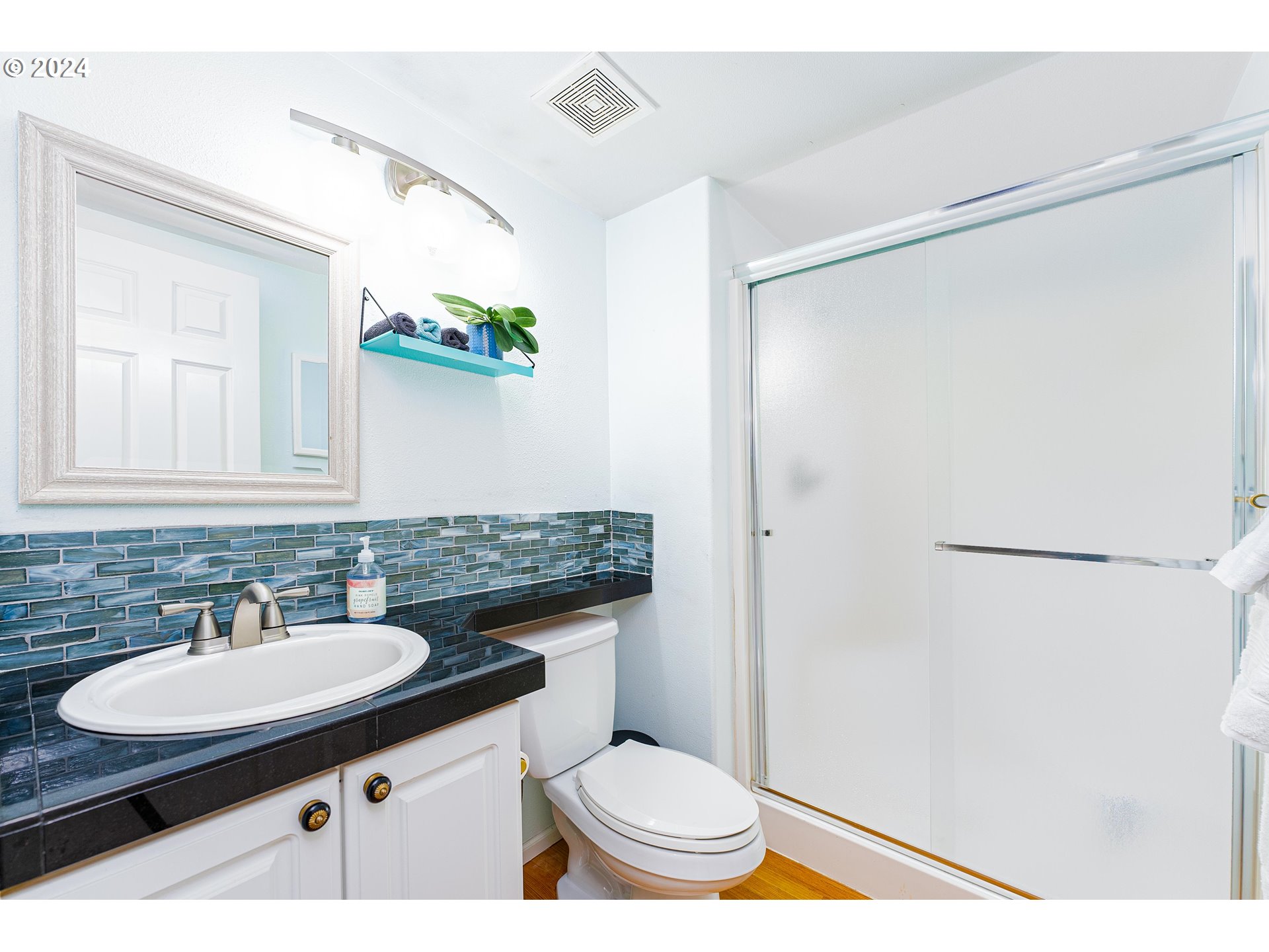 14915 Southwest Osprey Court Beaverton, OR 97007 - Photo 26 of 38 a bathroom with a sink toilet and a mirror