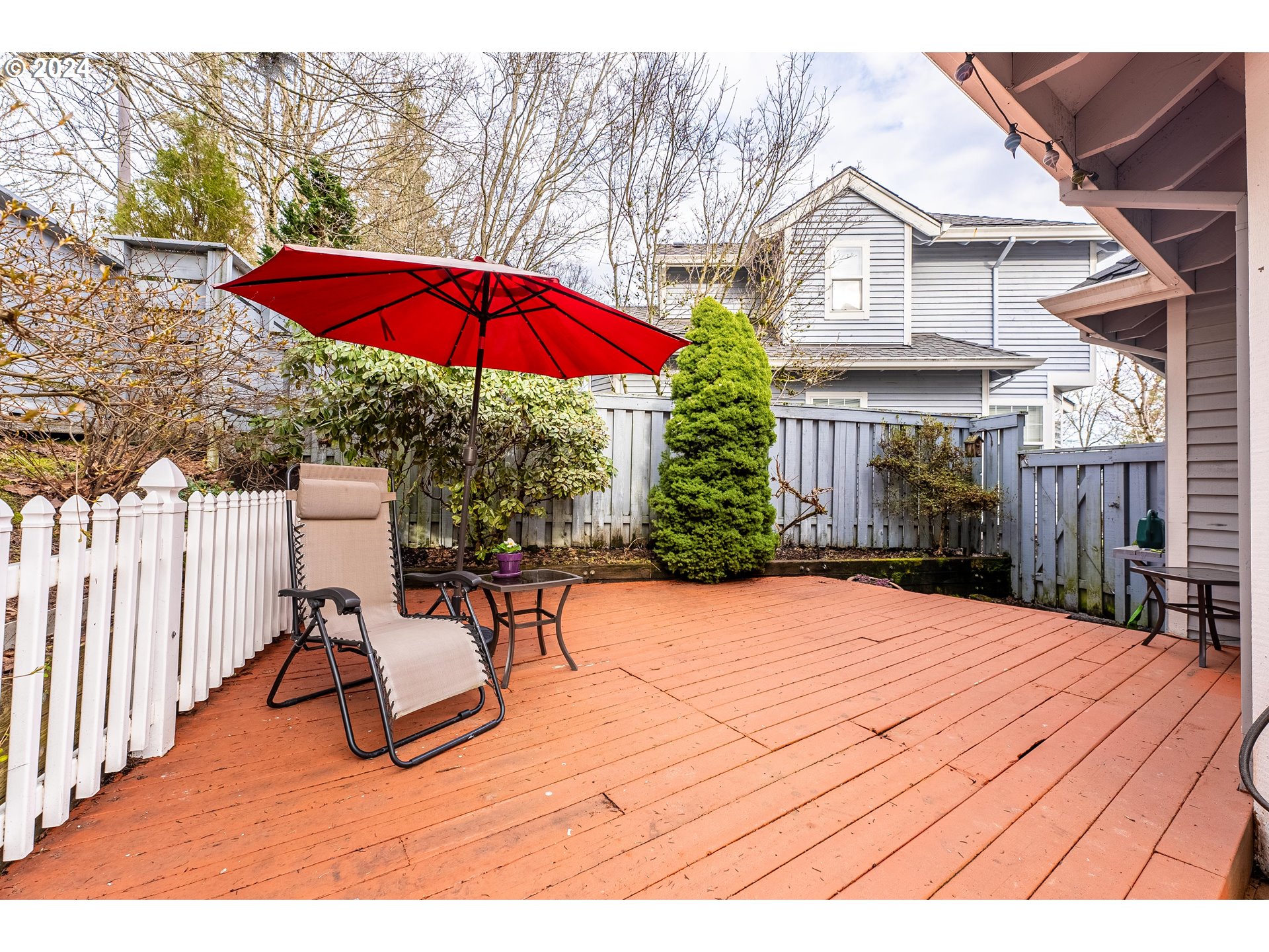 14915 Southwest Osprey Court Beaverton, OR 97007 - Photo 30 of 38 a view of patio with a table and chairs under an umbrella