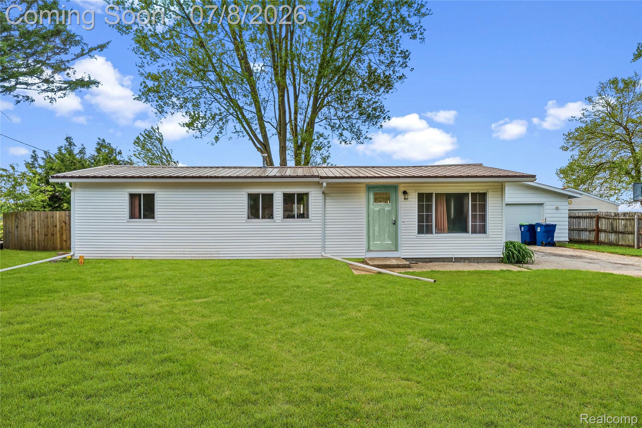 5698 McGrandy Road Bridgeport, MI 48722 - Photo 1 of 26 Ranch-style exterior featuring white siding, a metal roof, and a light green front door