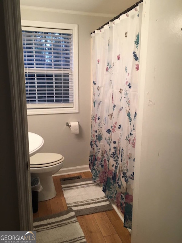 12754 State Route 96 Fort Valley, GA 31030 - Photo 16 of 26 a bathroom with a toilet and a shower curtain