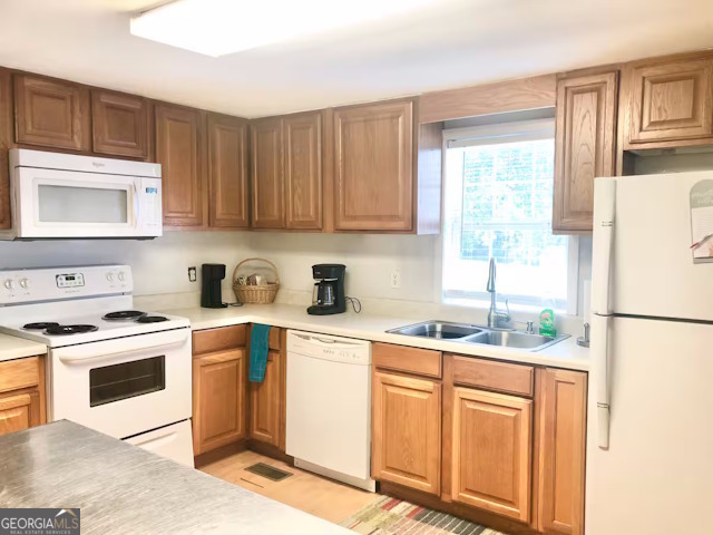 12754 State Route 96 Fort Valley, GA 31030 - Photo 6 of 26 a kitchen with stainless steel appliances granite countertop a refrigerator sink stove and white cabinets