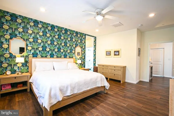 a bedroom with a bed table and a window