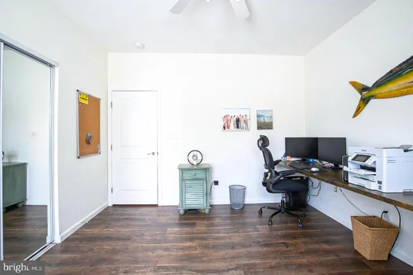 a view of a workspace with furniture and a window