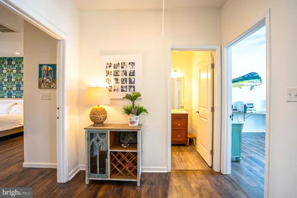 a view of a hallway view with wooden floor and living room