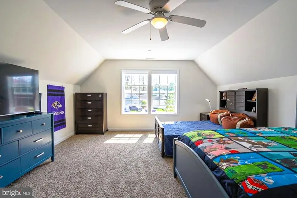 a bedroom with a bed and a dresser in it