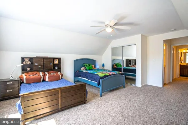 a living room with furniture and a baby crib