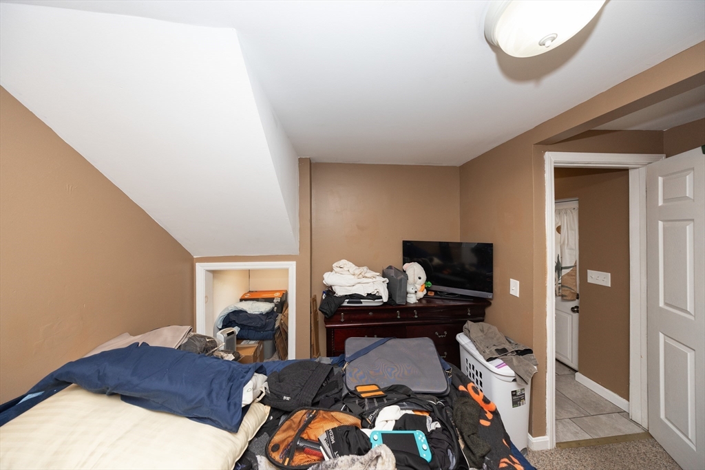 151 Mechanic Street Fitchburg, MA 01420 - Photo 11 of 42 a bedroom with a bed and gym equipment