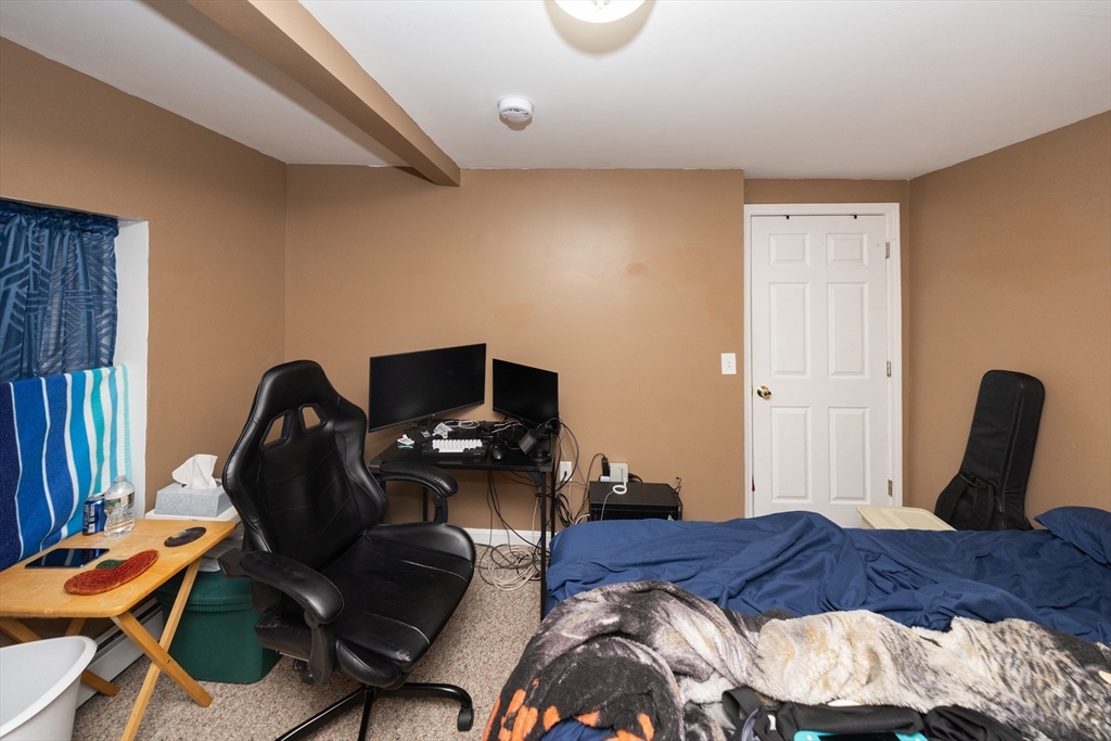 151 Mechanic Street Fitchburg, MA 01420 - Photo 12 of 42 a bedroom with furniture and a chair