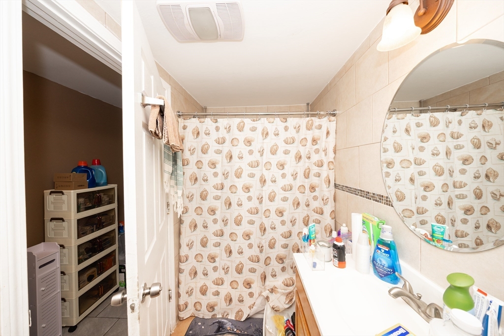 151 Mechanic Street Fitchburg, MA 01420 - Photo 18 of 42 a bathroom with a shower curtain and a curtain