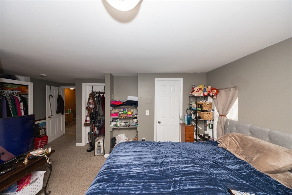 151 Mechanic Street Fitchburg, MA 01420 - Photo 20 of 42 a bed room with a bed and a closet