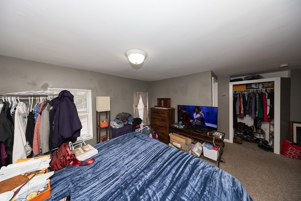 151 Mechanic Street Fitchburg, MA 01420 - Photo 21 of 42 a living room with furniture a flat screen tv and a closet